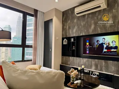 a living room with a couch and a tv at 8 Kia Peng Suites KLCC By HeyStay Management in Kuala Lumpur