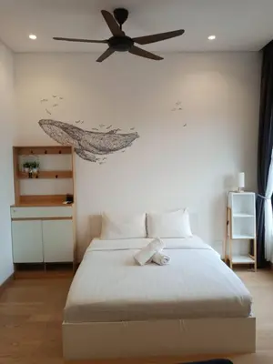a bedroom with a bed with a ceiling fan at Lotus Suite Scarletz KLCC in Kuala Lumpur