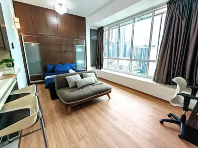 a living room with a couch and a chair at Parkview Serviced Apartment in Kuala Lumpur