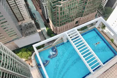 an overhead view of two people swimming in a pool on a building at Parkview Serviced Apartment in Kuala Lumpur