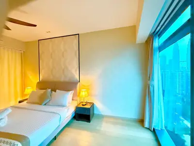 a hotel room with a bed and a window at Eaton KLCC Infinity Pool by NP in Kuala Lumpur