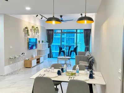 a dining room and living room with a table and chairs at Eaton KLCC Infinity Pool by NP in Kuala Lumpur