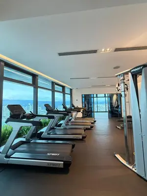 a gym with a row of treadmills at Eaton KLCC Infinity Pool by NP in Kuala Lumpur