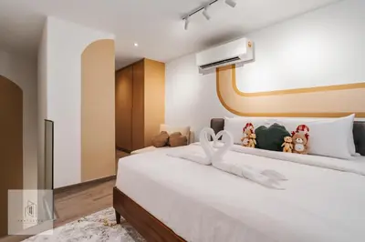 a bedroom with a bed with stuffed animals on it at Agile Bukit Bintang by Fantastic Home in Kuala Lumpur