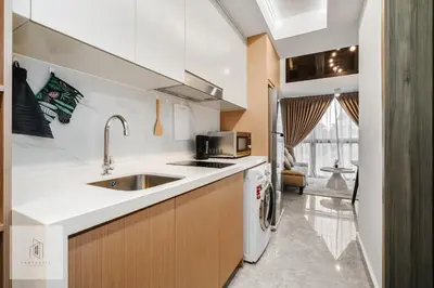 a kitchen with a sink and a refrigerator at Agile Bukit Bintang by Fantastic Home in Kuala Lumpur