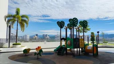 a playground with a slide and play equipment and palm trees at Homestay Kuala Lumpur in Kuala Lumpur