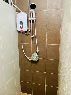 a shower in a bathroom with a soap dispenser at Homestay Kuala Lumpur in Kuala Lumpur