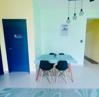 a blue table with four chairs and a blue door at Homestay Kuala Lumpur in Kuala Lumpur
