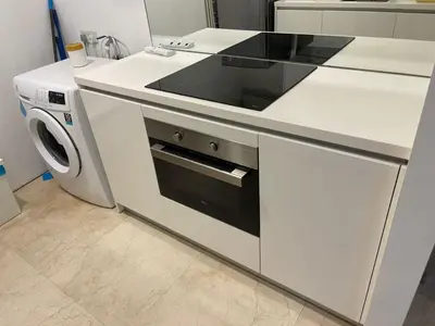 a white kitchen with a stove and a dishwasher at Vortex Suites KL33 in Kuala Lumpur
