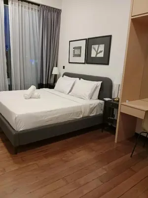 a bedroom with a bed with white sheets and white pillows at MAXX ROYEL AT OPUS RESiDENCE in Kuala Lumpur
