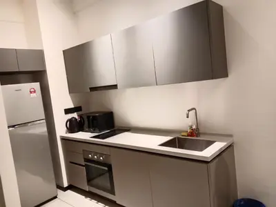 a small kitchen with a sink and a refrigerator at MAXX ROYEL AT OPUS RESiDENCE in Kuala Lumpur