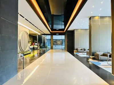 a lobby of a building with chairs and tables at MAXX ROYEL AT OPUS RESiDENCE in Kuala Lumpur
