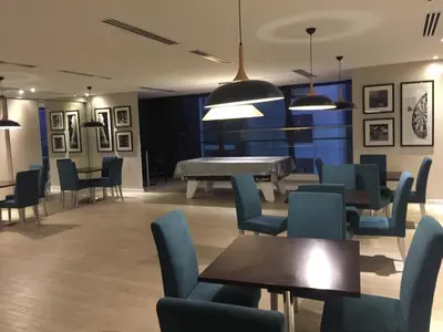 a waiting room with tables and chairs and a piano at M CITY 2 Bed KLCC BY D in Kuala Lumpur