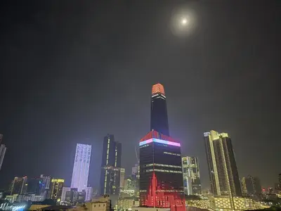 a tall building lit up in red and purple at Axon Home Stay by Privet Apartment in Kuala Lumpur