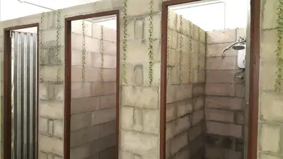 a shower with two glass doors in a bathroom at PODs The Backpackers Home & Cafe, Kuala Lumpur in Kuala Lumpur