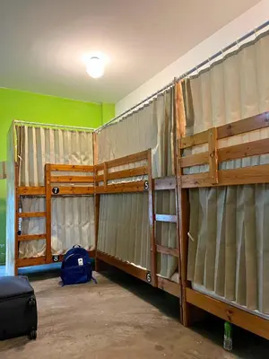 a room with two bunk beds in a room at PODs The Backpackers Home & Cafe, Kuala Lumpur in Kuala Lumpur