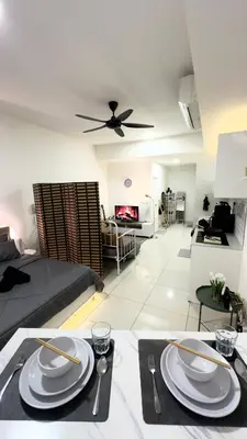 a living room with a table with plates and utensils at The Home by Fidi at Continew Residence in Kuala Lumpur