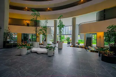 a lobby with potted plants in a building at The Atrium at Jalan Ampang by OKBnB - 3Bedroom Apartment with FREE WiFi & Carpark in Kuala Lumpur