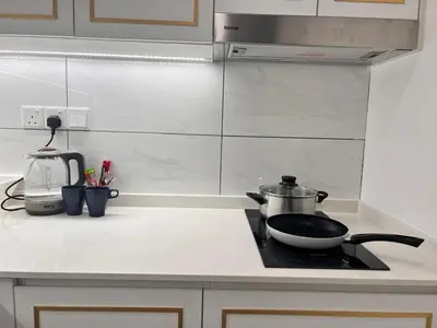 a kitchen counter with a stove with a pan on it at Axon Residence Bukit Bintang Pavilion KL in Kuala Lumpur