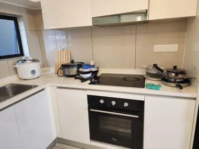 a kitchen with white cabinets and a stove top oven at Astoria 4r3b 5minsklcc bathtub waterfilter newcondo bigbalcony in Ampang