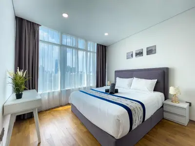 a bedroom with a large bed and a large window at Vortex Suites klcc By Sky House in Kuala Lumpur