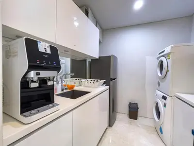 a white kitchen with a sink and a stove at Vortex Suites klcc By Sky House in Kuala Lumpur