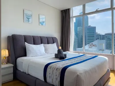 a bedroom with a large bed with a large window at Vortex Suites klcc By Sky House in Kuala Lumpur