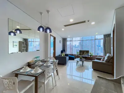 a living room and dining room with a table and chairs at Vortex Suites klcc By Sky House in Kuala Lumpur