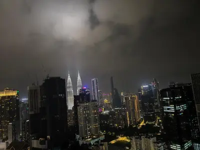 a view of a city skyline at night at Agile Service Suites Bukit Bintang By TRX in Kuala Lumpur