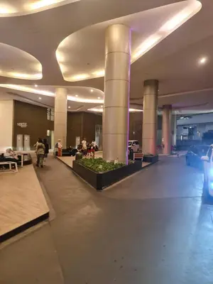 a lobby with columns and people sitting in a building at THE ROBERSTSON RESIDENT WITH VIEW Kuala Lumpur in Kuala Lumpur