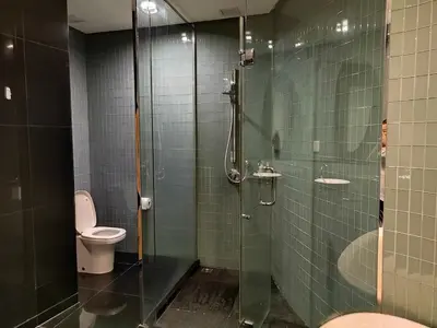 a bathroom with a toilet and a glass shower at Urban Oasis at St Mary klcc 1Bed2bath in Kuala Lumpur