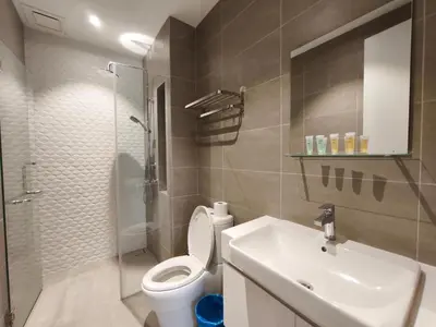 a bathroom with a toilet and a sink and a shower at Quill Residences KLCC, Fortune in Kuala Lumpur