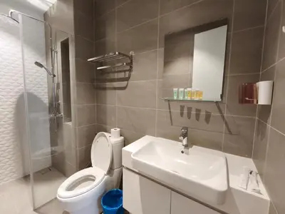 a bathroom with a toilet and a sink and a mirror at Quill Residences KLCC, Fortune in Kuala Lumpur
