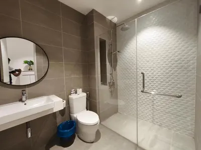 a bathroom with a shower and a toilet and a sink at Quill Residences KLCC, Fortune in Kuala Lumpur