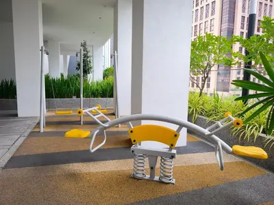 a yellow chair in front of a building at Quill Residences KLCC, Fortune in Kuala Lumpur