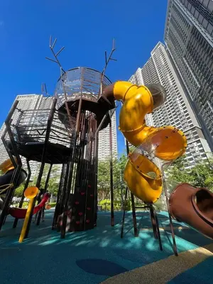 a playground with a slide in front of a city at The E48-10 Stay in Kuala Lumpur