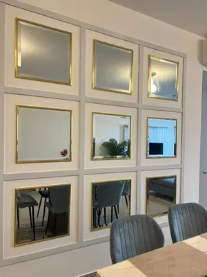 a wall of mirrors with a table and chairs at The E48-10 Stay in Kuala Lumpur