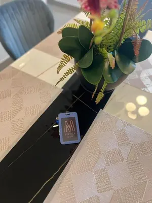 a sign on a table next to a potted plant at The E48-10 Stay in Kuala Lumpur