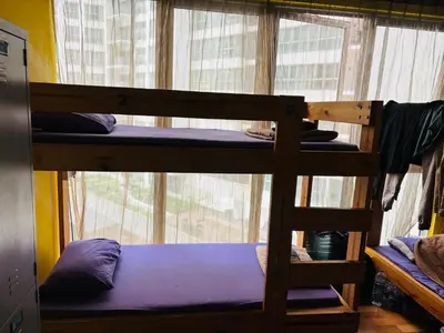 two bunk beds in a room with a window at Regalia Skypool KLCC Dorms By Tasrifa in Kuala Lumpur