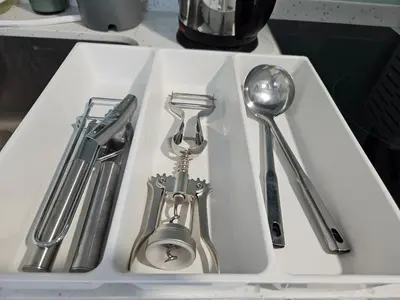 a white sink with silver utensils in it at SerenityStayatRiveria KL Sentral in Kuala Lumpur
