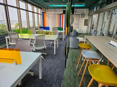 a classroom with tables and chairs and windows at SerenityStayatRiveria KL Sentral in Kuala Lumpur