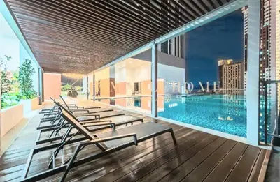 a row of chairs sitting on a building with a pool at Chambers Kl by MRJ in Kuala Lumpur