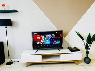 a flat screen tv sitting on top of a white cabinet at Chambers Kl by MRJ in Kuala Lumpur