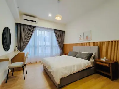a bedroom with a bed and a desk and a desk at Agile SkyView Suites KL in Kuala Lumpur