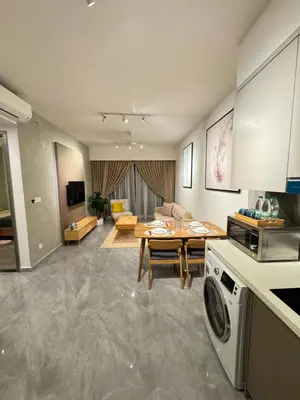 a kitchen and living room with a table and a washer at Agile Bukit Bintang by SOD in Kuala Lumpur