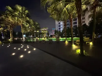 a park at night with palm trees and lights at Agile Bukit Bintang by SOD in Kuala Lumpur
