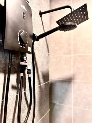 a shower with a hair dryer attached to a wall at Studio Room at Neu Suites, Jalan Ampang KL in Kuala Lumpur