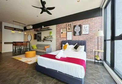 a bedroom with a large bed and a brick wall at Scarletz Suites KLCC by WSD in Kuala Lumpur