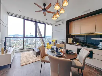 a kitchen and dining room with a table and chairs at Scarletz Suites KLCC by WSD in Kuala Lumpur