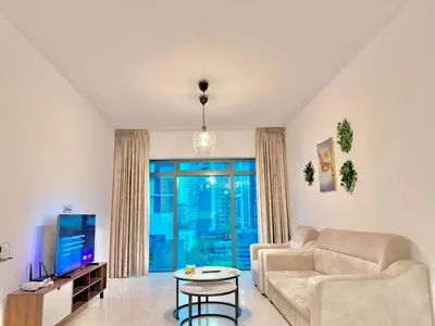 a living room with a couch and a tv at PANORAMIC SUITES at Eaton residence in Kuala Lumpur
